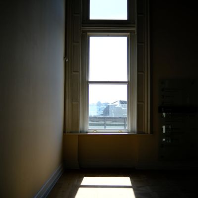 Sunlight streaming through a window onto a wooden floor.
